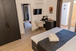 a bedroom with a bed and a desk and a chair at Casa de Ámbar, Bed&Breakfast in Alhaurín el Grande +25 photos