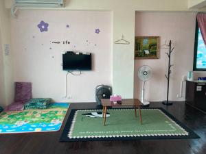 a living room with a bed and a tv at Guanshan Fukuda Homestay in Guanshan