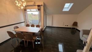 a dining room with a wooden table and chairs at Apartment in Laatzen! contactless check-in in Hannover