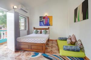 a bedroom with a bed and a chair in it at Comfort Holiday Home in Baga