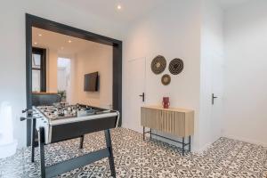 a living room with a stove in the middle of a room at Spacious house 11 bedrooms 8 bathrooms 22 people. in Roubaix +44 photos