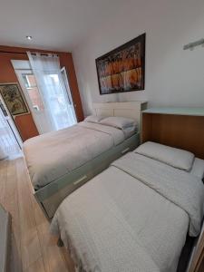 a bedroom with two beds and a window at Valencia Canyamelar Beach Apartments in Valencia