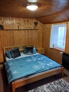 a bedroom with a bed in a wooden room at Prázova Bouda in Dobré