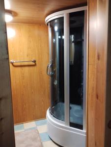 a bathroom with a shower with a glass door at Prázova Bouda in Dobré