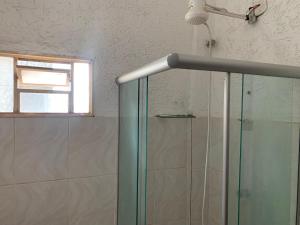 a shower with a glass door in a bathroom at 105 Apartamento exclusivo Wi-Fi in Brasilia