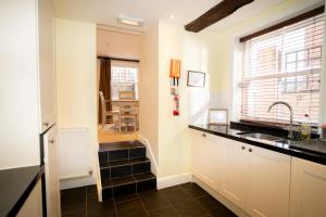 a kitchen with a sink and a counter top at The Bakehouse - central townhouse sleeps 8 people in Winchester