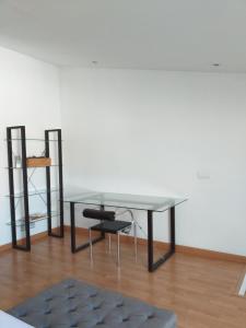 una mesa de cristal y una silla en una habitación en Apartamentos La Pergola Castellón, en Castellón de la Plana