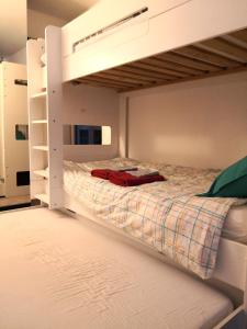 a bedroom with a bunk bed with a red blanket at Appartement vue Seine - Duplex 3 terrasses - 3 Chambres in Saint-Ouen