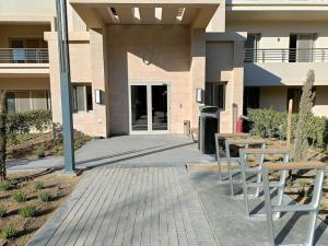 a building with two tables and chairs in front of it at cozy house in Cairo