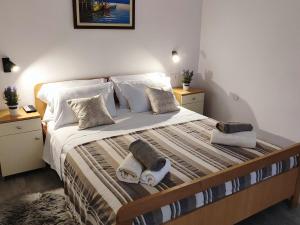 a bedroom with a large bed with towels on it at Apartment Castellina in Kaštela