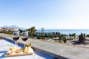a couple of glasses of wine sitting on a ledge at Palazzo Mirelli in Naples