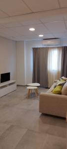 a living room with a couch and a table at Apart Hotel Concepcion in Concepción