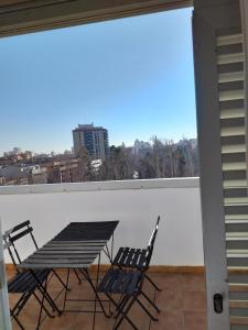 a table and chairs on a balcony with a view at Apartamentos La Pergola Castellón in Castellón de la Plana