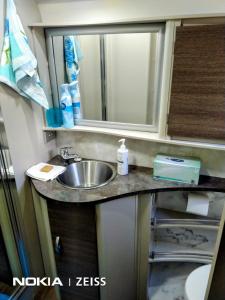 冈尼达RV Caravan in Rural Setting on Edge of Town close to AgQuip的带水槽和镜子的浴室
