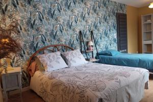 a bedroom with a bed and a wall mural at La Osmonière - Maison 6 personnes - Tout inclus in Saint-Méloir-des-Ondes