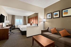 a hotel room with a couch and a bed at Comfort Suites University Las Cruces in Las Cruces
