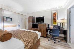 a hotel room with a bed and a desk and a chair at The Capitol Hotel Downtown, Ascend Hotel Collection in Nashville