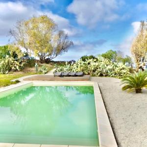 a swimming pool in the backyard of a house at Lispusada B&B in Biancareddu