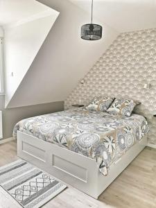 a bedroom with a bed with a white bed frame at Maison 3* sur la Côte de Granit Rose in Trégastel