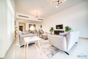 a living room with couches and a table at Dazzling 4BR Villa with Assistant’s Room at Al Dana Villa Sharm, Fujairah by Deluxe Holiday Homes in Fujairah