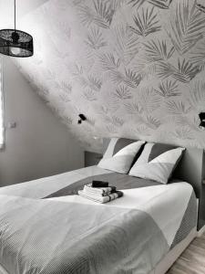 a bedroom with a bed with a white wall at Maison 3* sur la Côte de Granit Rose in Trégastel