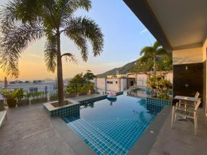 a swimming pool with a view of the ocean at Twin Villas Seaview Kata in Kata Beach