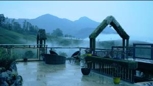 a balcony with a view of a misty mountain at Parakkat Nature Resort in Munnar