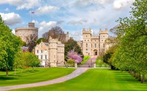 a castle with a green lawn in front of it at Stylish Spacious Apartment in Central Windsor in Windsor