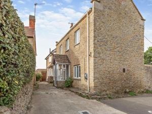an old brick building with a stone wall at 2 Bed in Burton Bradstock 93076 in Burton Bradstock