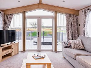 a living room with a couch and a large window at 2 Bed in St Andrews 90764 in St Andrews