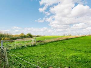 a fence in the middle of a green field at 2 Bed in Whitstable 90344 in Whitstable