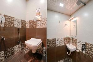 a bathroom with a toilet and a sink at FabExpress Gulshan Grand in Mumbai