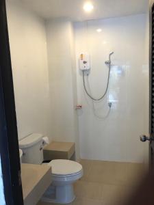 a bathroom with a toilet and a shower at Rawai Sea Beach in Phuket Town
