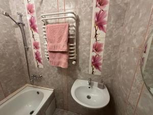 ein Badezimmer mit einem Waschbecken, einem WC und einer Badewanne in der Unterkunft Айстра in Lwiw