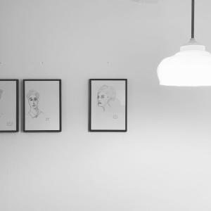 a group of framed drawings on a wall at Künstlerzimmer in Straden