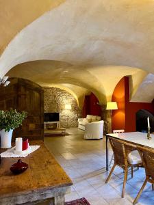 a living room with a table and a couch at Masia Quelet in La Vall de Bianya