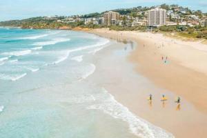 a group of people walking on a beach at The Sanctuary - Family Retreat - Noosa Hinterland in North Arm