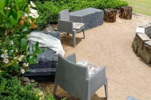 a patio with two chairs and a couch in a yard at The Sanctuary - Family Retreat - Noosa Hinterland in North Arm