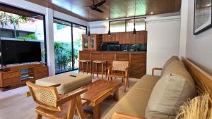 a living room with a couch and a table at Villa Baru 3 Bedroom in Tabanan