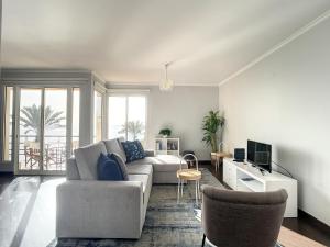 a living room with a couch and a table at Sunny Side by Atlantic Holiday in Madalena do Mar