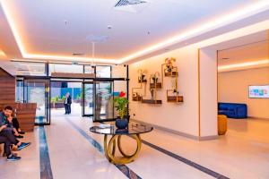 a lobby of a building with a table and people at ORBI CiTY-sea view aparthotel in Batumi