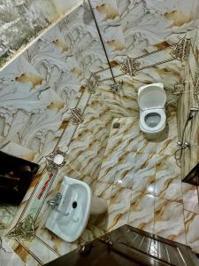 a bathroom with a sink and a urinal and a toilet at Millat Hotel G9-1 in Islamabad +22 photos