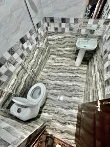 uma casa de banho com um WC e um lavatório em Al Atif Hotel em Islamabad