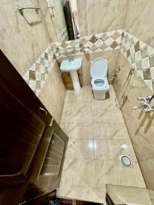 a bathroom with a toilet and a sink at Millat Hotel G9-1 in Islamabad