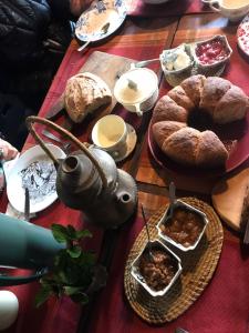 a table with bread and a tea pot and food at Costa del azul in Los Repollos