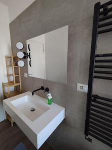 a bathroom with a white sink and a mirror at Casa Felix in Giulianova