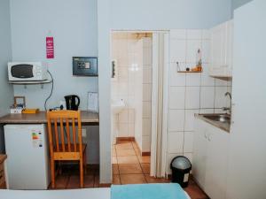 a small kitchen with a sink and a refrigerator at Stay at 12 Guesthouse and Selfcatering in Middelburg