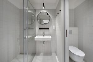 a bathroom with a shower and a sink and a toilet at Apartmány Velká Morava in Dolní Morava