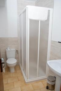 a bathroom with a shower with a toilet and a sink at Pension Cuatro Vientos in Cuevas del Almanzora