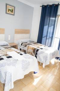 Postel nebo postele na pokoji v ubytování Pension Cuatro Vientos